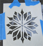 snowflake template taped to window