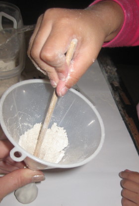 Use a pen to push the flour down