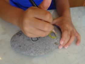 Kids drawing on rock